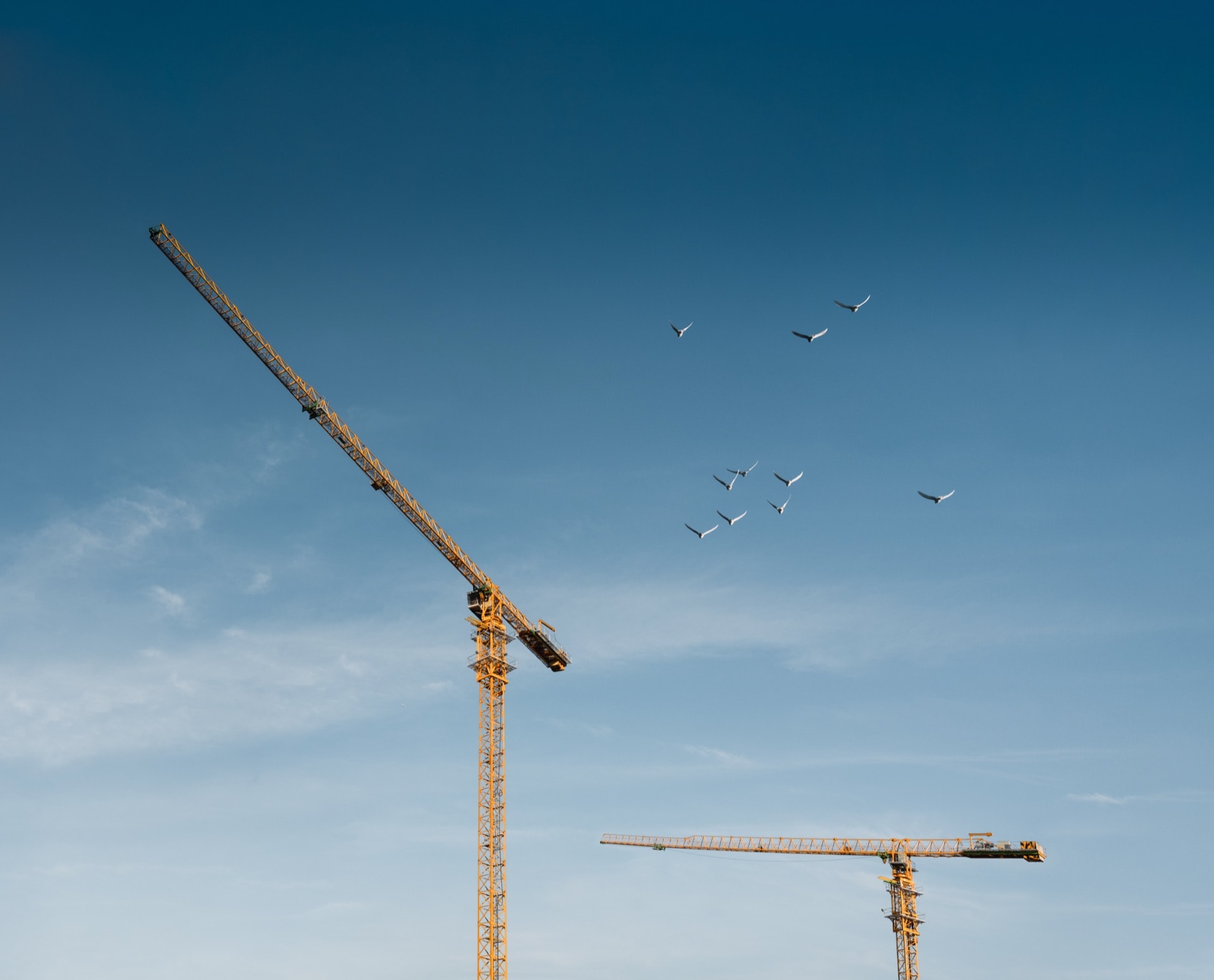Construction crane rising into a clear blue sky
